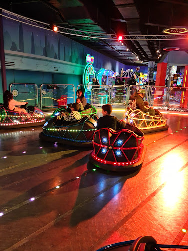 Children playing on bumper cars at a soft play centre